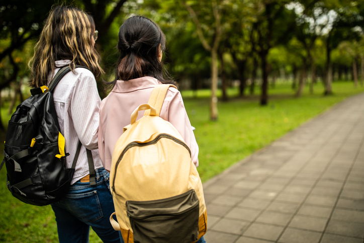 Two girl classmates walking together.