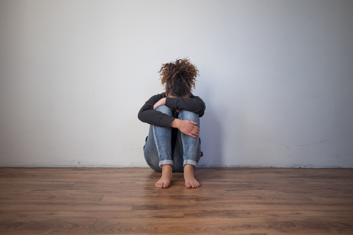 Girl holding her head in her hands